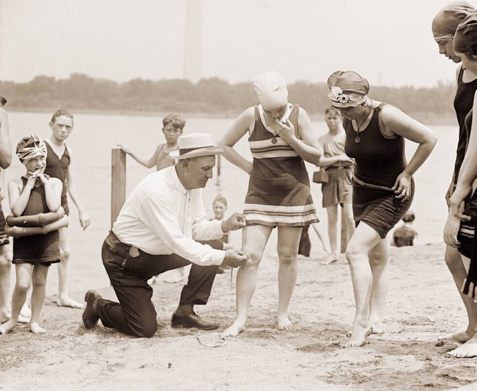 Woman having her swimsuit measured for length violations on a Washington DC beach in the 1920s (silver print), 1922. (Photo by GraphicaArtis/Getty Images)