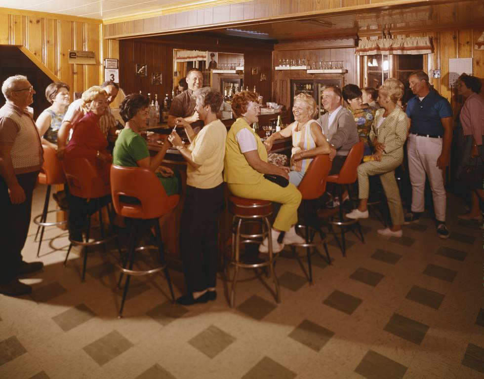 Enjoying drinks at the bar at Better Days Farm, a vacation spot. | Location: Greenville, New York, USA.  (Photo by Eric Bard/Corbis via Getty Images)