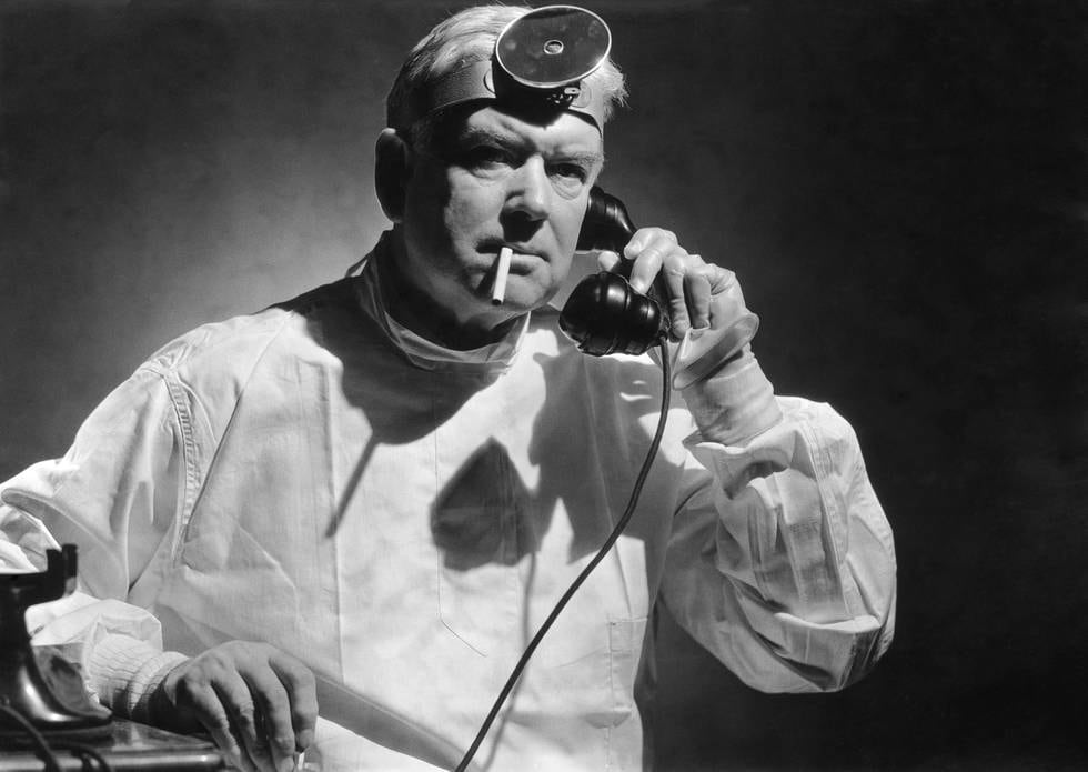 A doctor smoking a cigarette while taking a phone call, circa 1950. (Photo by FPG/Hulton Archive/Getty Images)